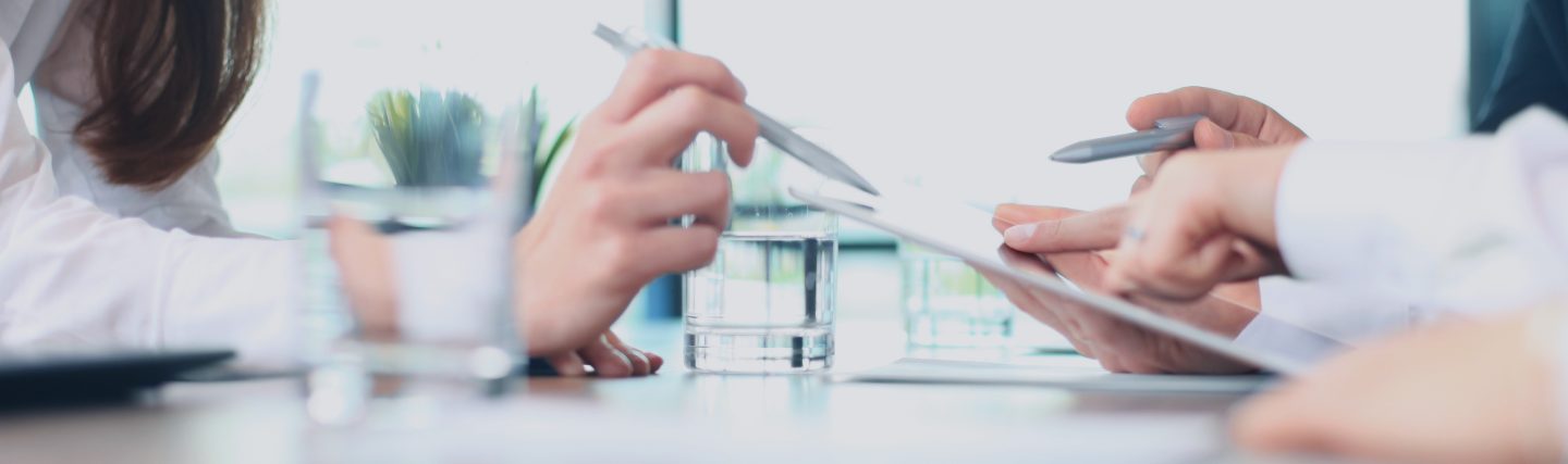 staff in a meeting using an ipad